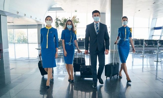 four-young-stylish-airline-employees-wearing-medical-masks-airport-terminal_447912-4024-transformed